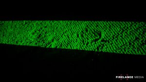 Green laser highlighting a footprint during night tracking